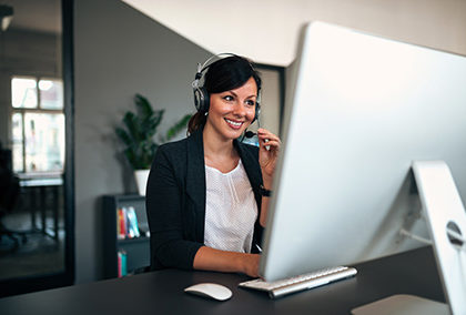 Female consulting manager with headset working in the office.