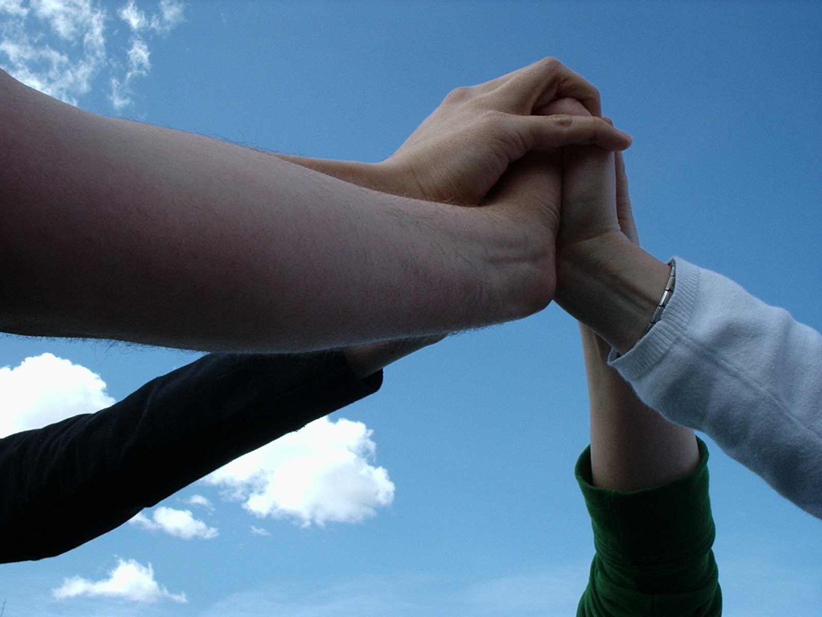 Team touching hands by Teak Sato