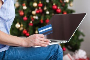 Woman shopping online with credit card for christmas