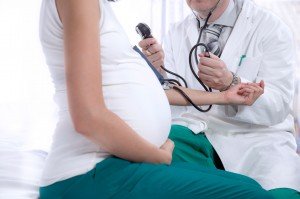 doctor measures the pressure of a pregnant woman